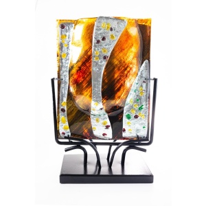 Shown here in front view, the vase imparts its coloration to the light penetrating its translucent composition resulting in a tawny, autumn dawn light cast gently all about the piece.